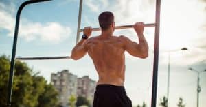 A strong man is doing 20 and even more pull-ups